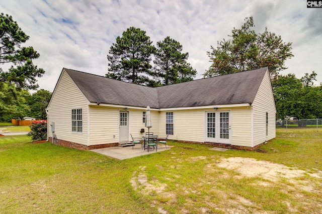 rear view of house featuring a yard and a patio