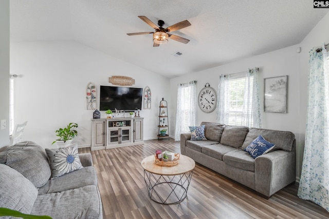 living room featuring a textured ceiling, ceiling fan, lofted ceiling, and hardwood / wood-style flooring