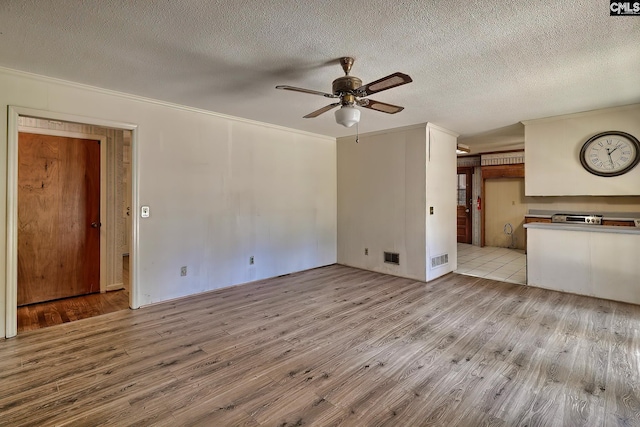 unfurnished living room featuring light hardwood / wood-style floors, a textured ceiling, and ceiling fan