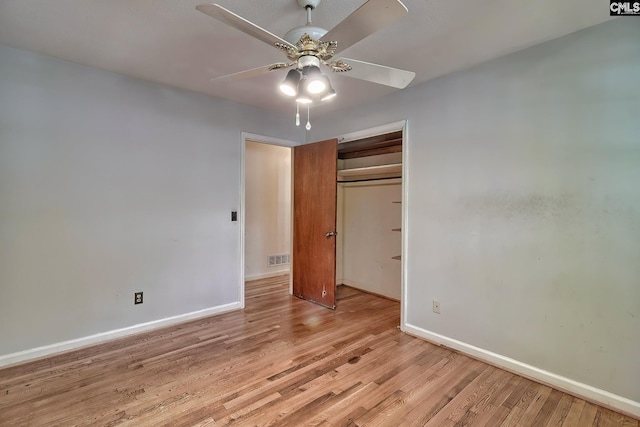 unfurnished bedroom featuring light wood-type flooring, ceiling fan, and a closet