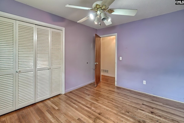 unfurnished bedroom with a closet, ceiling fan, and light hardwood / wood-style flooring