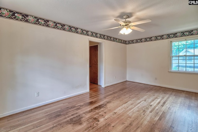 unfurnished room with light wood-type flooring, ceiling fan, and a textured ceiling