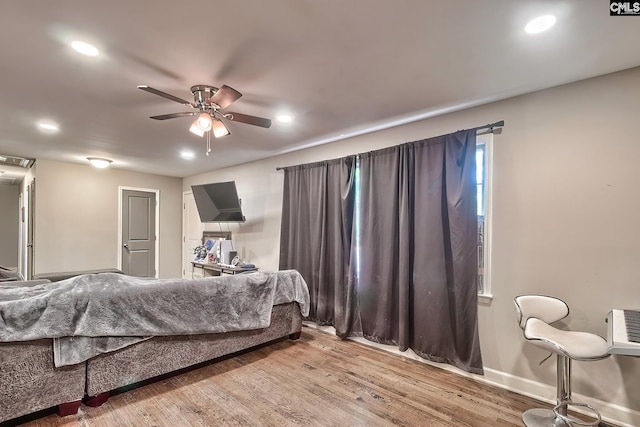 bedroom with ceiling fan and wood-type flooring