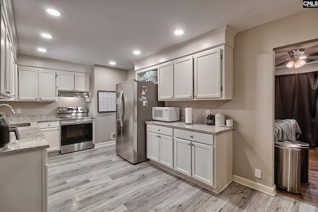 kitchen with light hardwood / wood-style floors, sink, white cabinetry, and stainless steel appliances