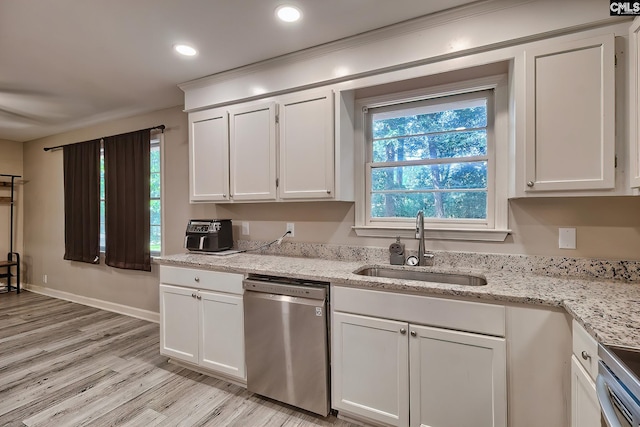 kitchen featuring white cabinets, appliances with stainless steel finishes, light hardwood / wood-style floors, and sink