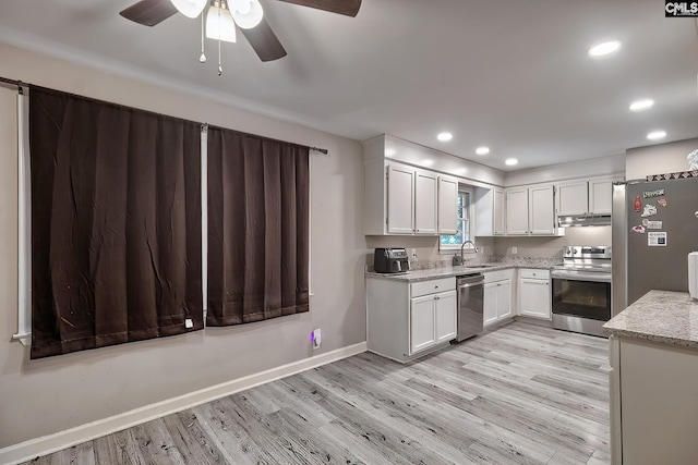 kitchen featuring stainless steel appliances, white cabinetry, light hardwood / wood-style floors, and sink