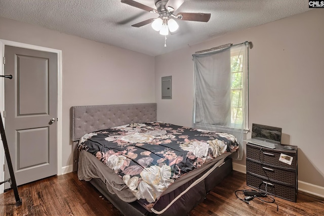 bedroom with electric panel, ceiling fan, dark hardwood / wood-style flooring, and a textured ceiling