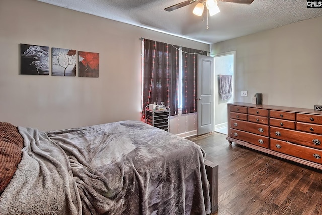 bedroom with a textured ceiling, ceiling fan, and dark hardwood / wood-style floors