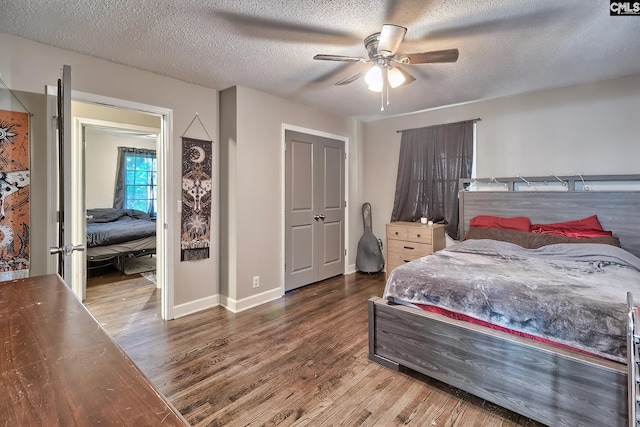 bedroom featuring ceiling fan, wood-type flooring, and a textured ceiling