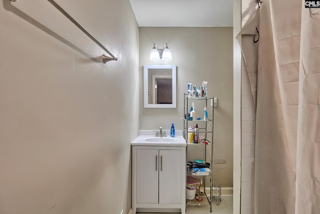 bathroom featuring tile patterned floors, vanity, and walk in shower