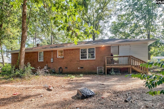 back of property with a wooden deck