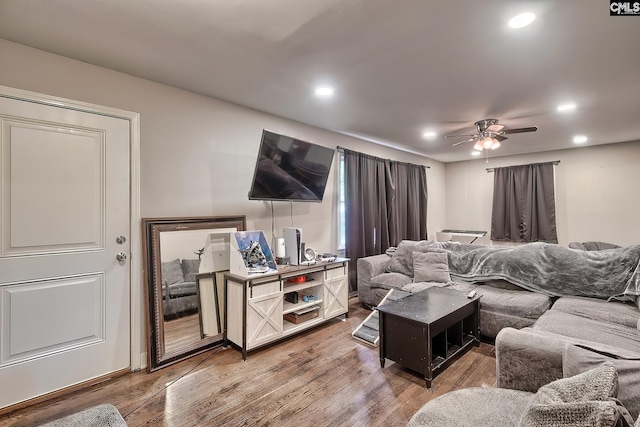 living room featuring ceiling fan and hardwood / wood-style flooring