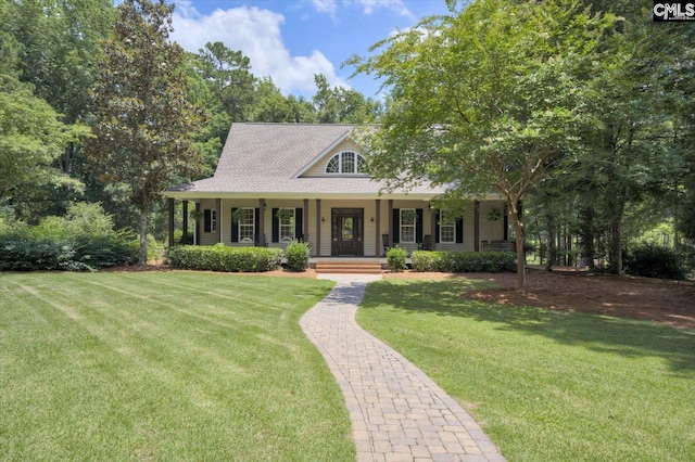 farmhouse inspired home with covered porch and a front lawn