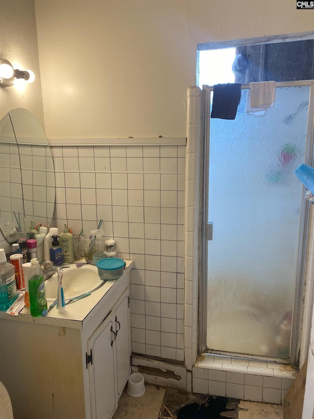 bathroom featuring vanity, tile walls, and walk in shower