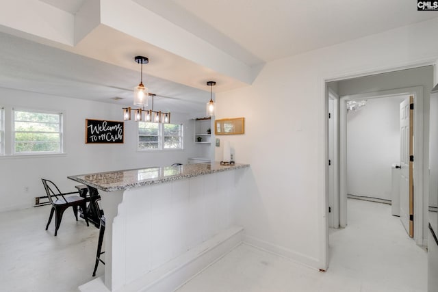 bar featuring a healthy amount of sunlight, pendant lighting, and light stone countertops