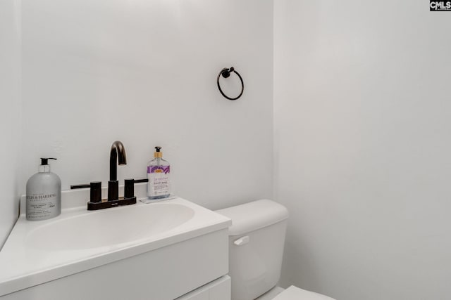 bathroom featuring toilet and vanity