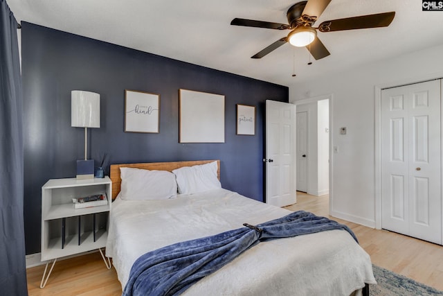 bedroom with a closet, ceiling fan, and light hardwood / wood-style floors