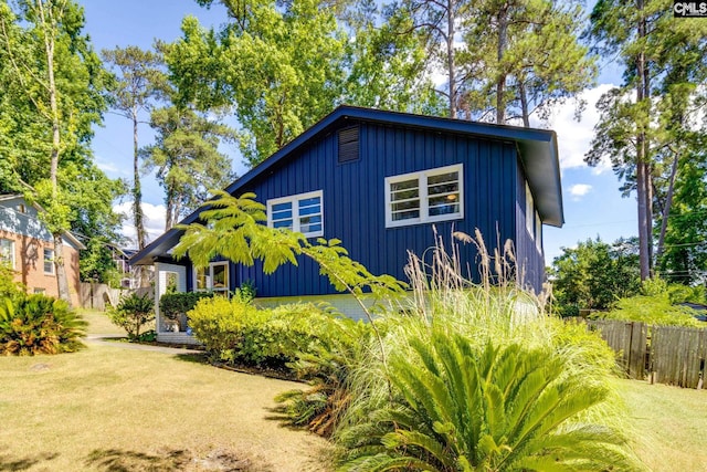 view of side of home featuring a yard