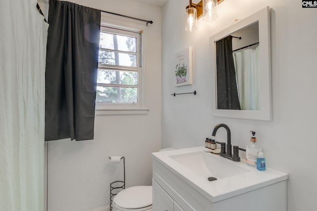 bathroom with toilet and vanity