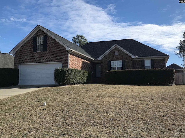 view of property with a garage and a front lawn