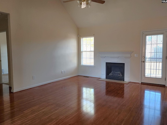 unfurnished living room featuring hardwood / wood-style floors, high vaulted ceiling, and ceiling fan