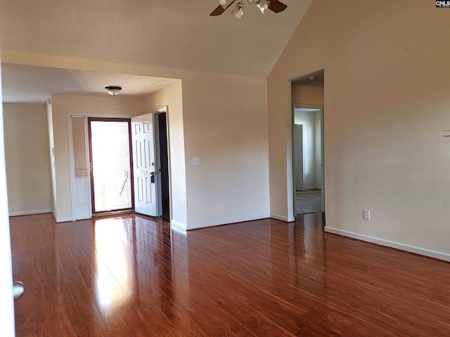 spare room featuring high vaulted ceiling, dark hardwood / wood-style floors, and ceiling fan