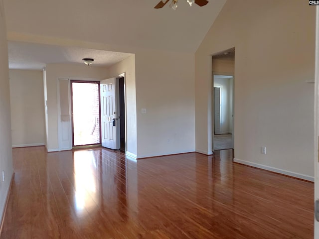 spare room featuring hardwood / wood-style flooring, ceiling fan, and high vaulted ceiling