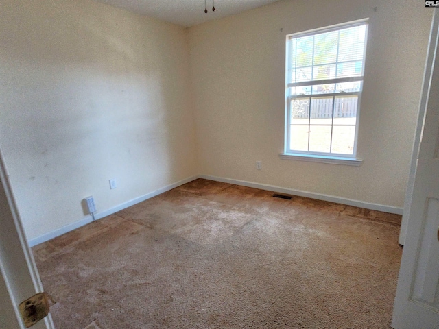 spare room with light colored carpet