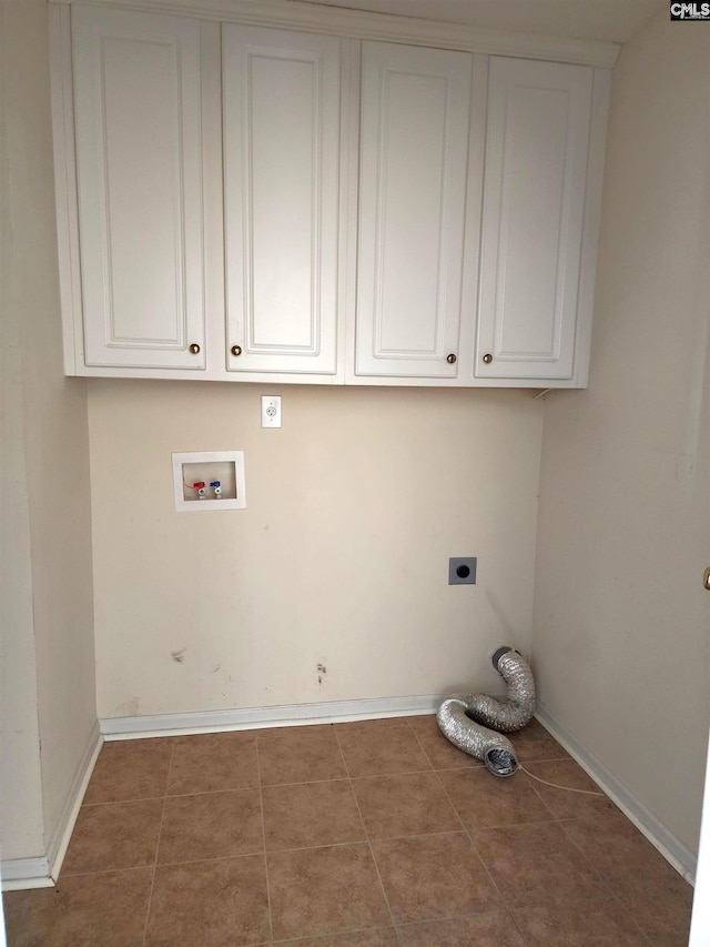 laundry room featuring electric dryer hookup, washer hookup, tile patterned floors, and cabinets