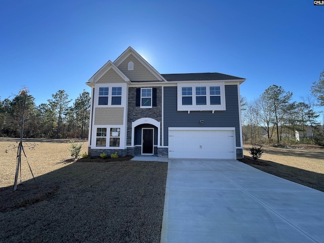 view of front of property featuring stone siding, an attached garage, and driveway