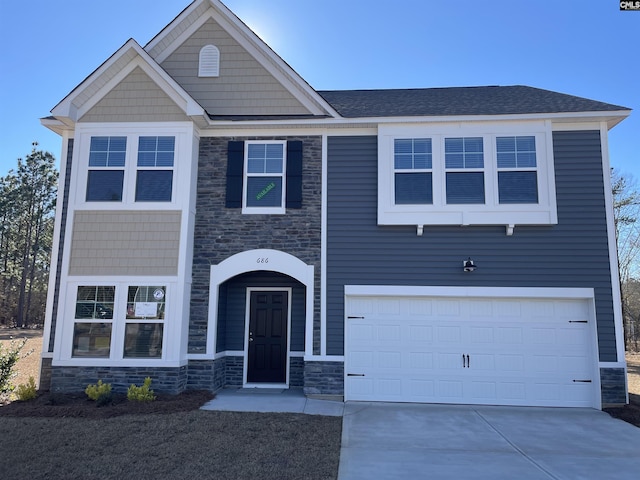 view of front of property with driveway, stone siding, a garage, and roof with shingles