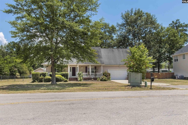 view of front of property with a garage, covered porch, and a front yard