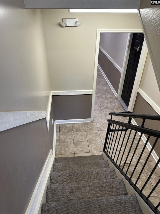 stairs with tile patterned floors