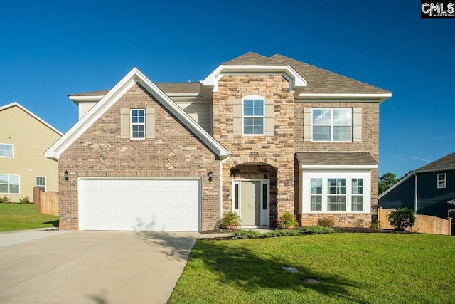 view of front facade with a front yard and a garage