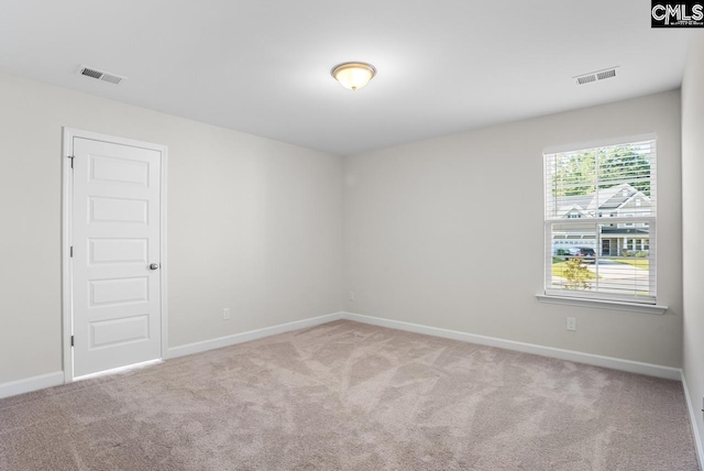 unfurnished room featuring light colored carpet