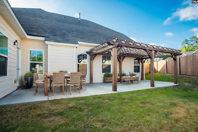 rear view of house with a pergola, a yard, and a patio