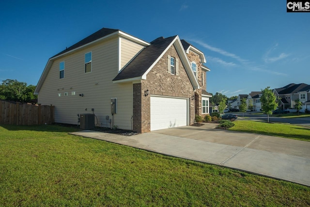 view of home's exterior with a yard, a garage, and central AC unit