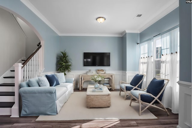 living room with dark hardwood / wood-style floors and crown molding