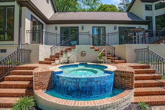 view of swimming pool featuring an in ground hot tub