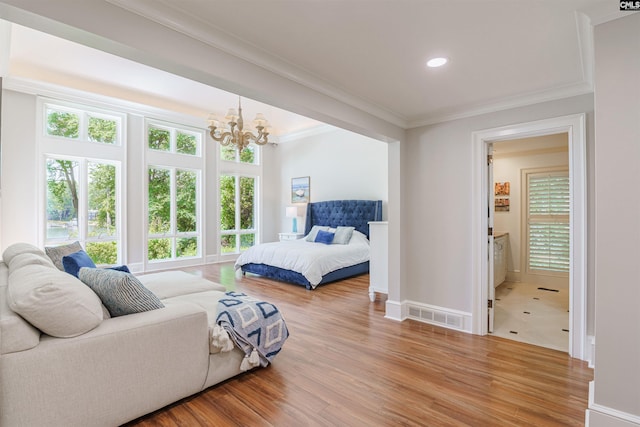 bedroom with ornamental molding, light wood-type flooring, and a notable chandelier