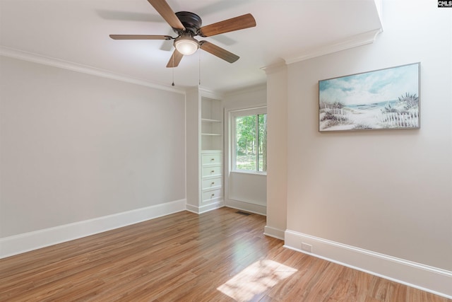 spare room with ornamental molding, ceiling fan, and light wood-type flooring