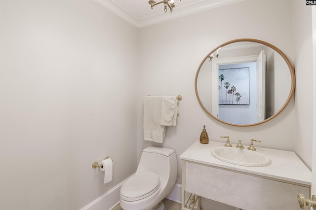 bathroom with vanity, crown molding, and toilet