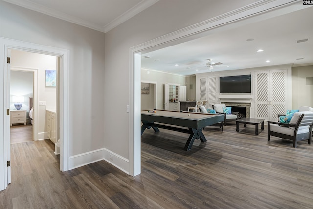 recreation room featuring crown molding, pool table, dark hardwood / wood-style flooring, ceiling fan, and a fireplace