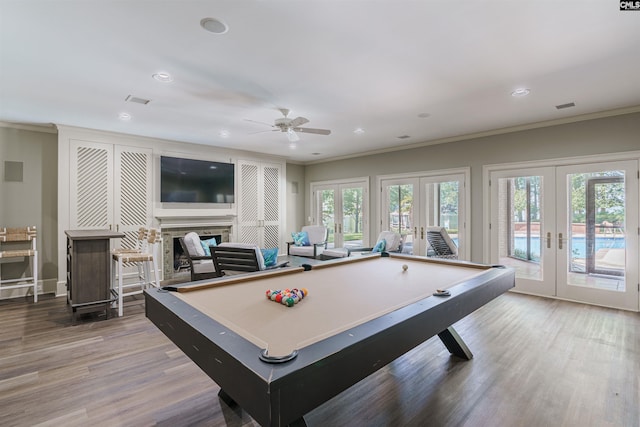 recreation room featuring french doors, light hardwood / wood-style floors, crown molding, ceiling fan, and billiards