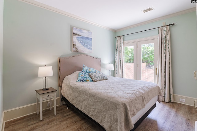 bedroom with crown molding and hardwood / wood-style floors