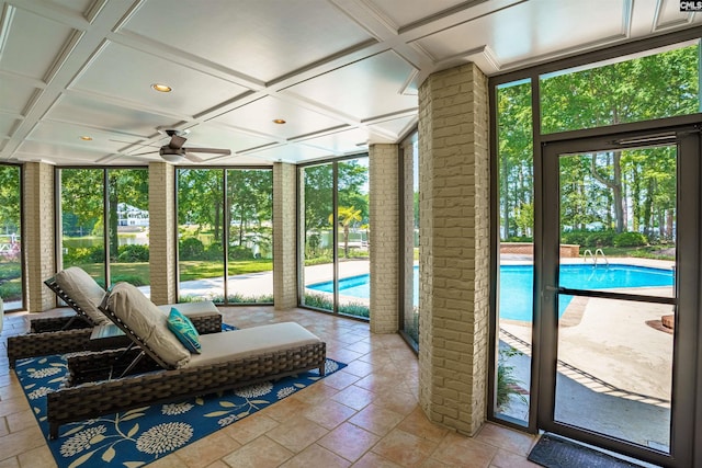 sunroom with coffered ceiling and ceiling fan