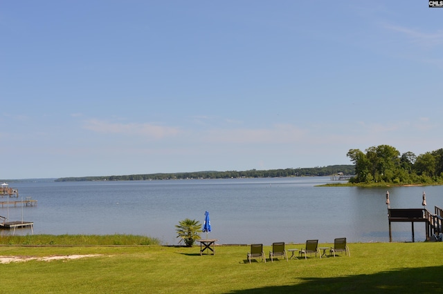 exterior space featuring a lawn and a water view