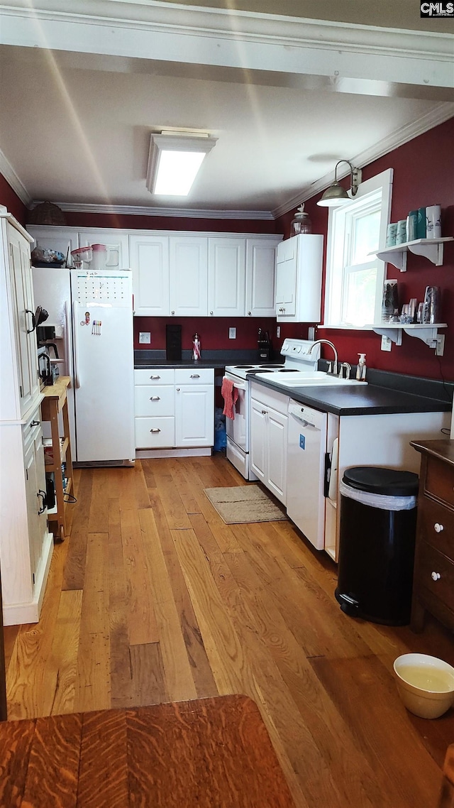 kitchen featuring crown molding, light hardwood / wood-style flooring, white appliances, and white cabinets