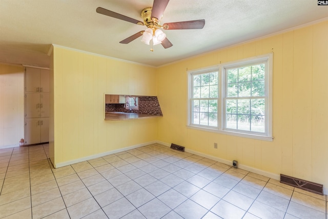 empty room featuring visible vents, a sink, and ornamental molding