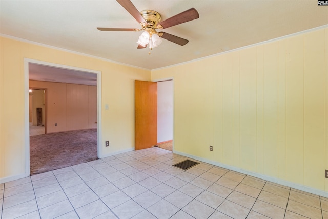 unfurnished room with ceiling fan, light carpet, visible vents, and crown molding